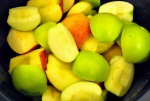 Step one for making this Homemade Apple Butter Recipe is to add the cut apples to your slow cooker.