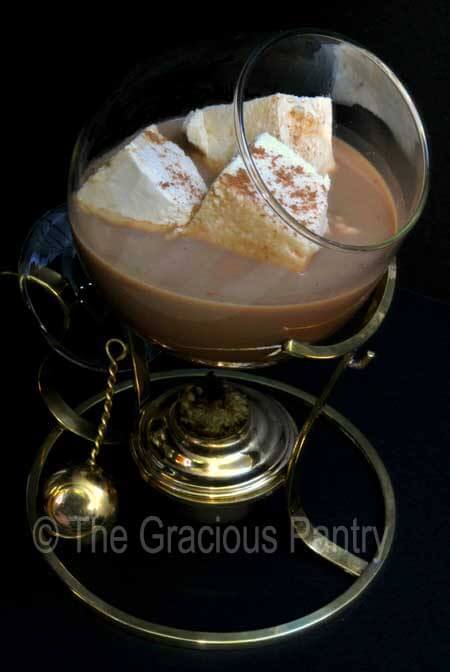 Hot chocolate with marshmallows in an old fashioned brandy warmer.