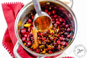 Step four of this Homemade Cranberry Sauce is to add the honey.