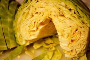 A cut cabbage that has been cored and is ready for slicing