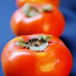 A row of persimmons sit waiting to be made into this Persimmon Butter Recipe.