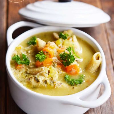 Homemade Chicken Soup in a white crock.