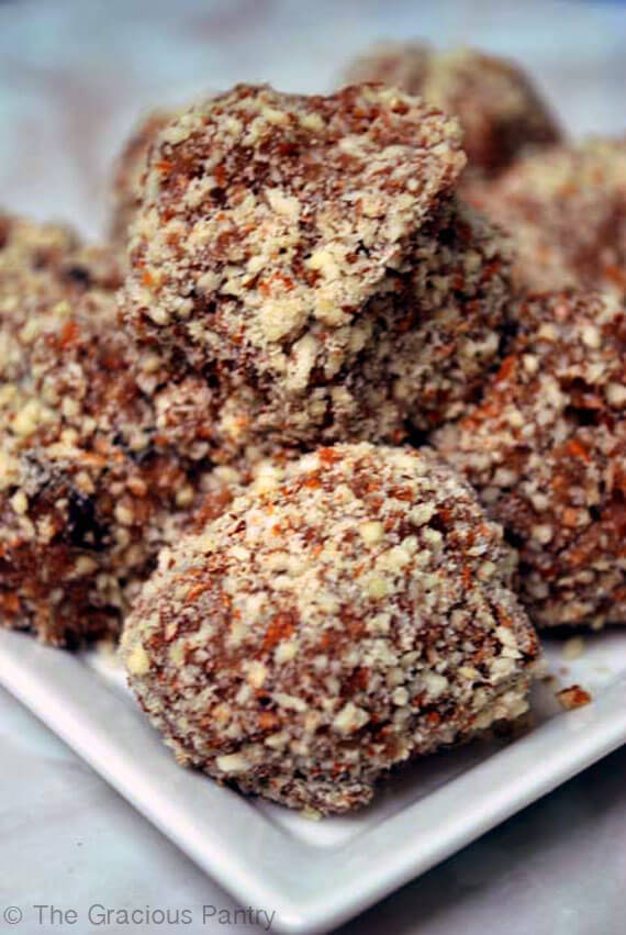 Clean eating cookie dough balls piled up on a white plate and ready to eat.