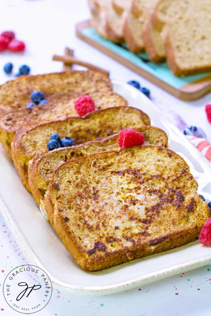 Four slices of Healthy French Toast are laid out on a serving platter, ready to eat.