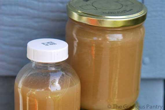 A bottle and jar filled with homemade chicken broth.