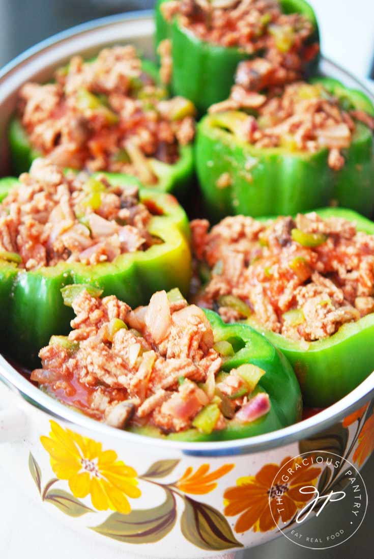 Clean Eating Stuffed Bell Peppers sitting in a pot, stuffed and ready to bake in the oven.