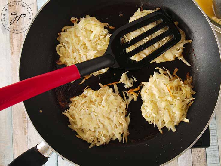 Make small potato patties and place them in your pan with butter for cooking.