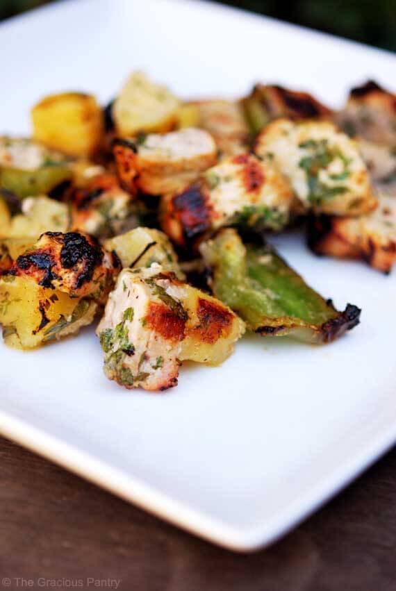 These Pineapple Pork Kebobs are off the stick and laying on a white, square plate, ready to eat.