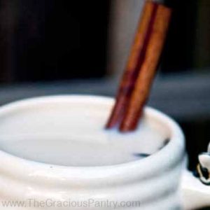 Chai Latte in a mug with a cinnamon stick.
