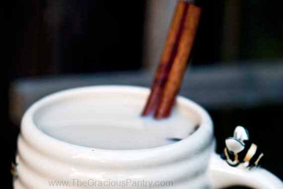 Chai Latte in a mug with a cinnamon stick.