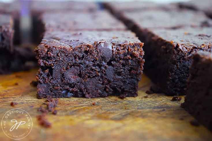 Cut brownies on a wood cutting board.