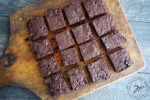 The freshly cut brownies, still sitting on the cutting board.