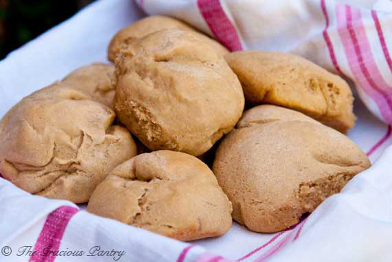 Several Homemade Dinner Rolls in a towel-lined basket.