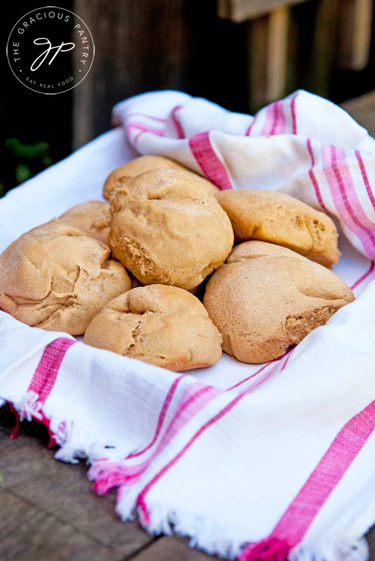 A basket filled with dinner rolls sits ready to serve. This Dinner Rolls Recipe is perfect for a weeknight dinner or your holiday table!