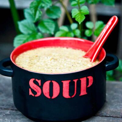 A black and red bowl sits filled with this Sick Day Soup Recipe