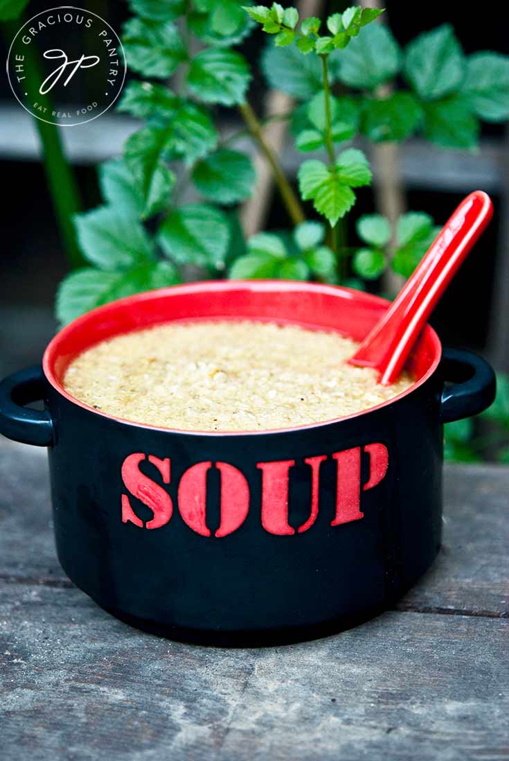 A black and red bowl sits filled with this Sick Day Soup Recipe