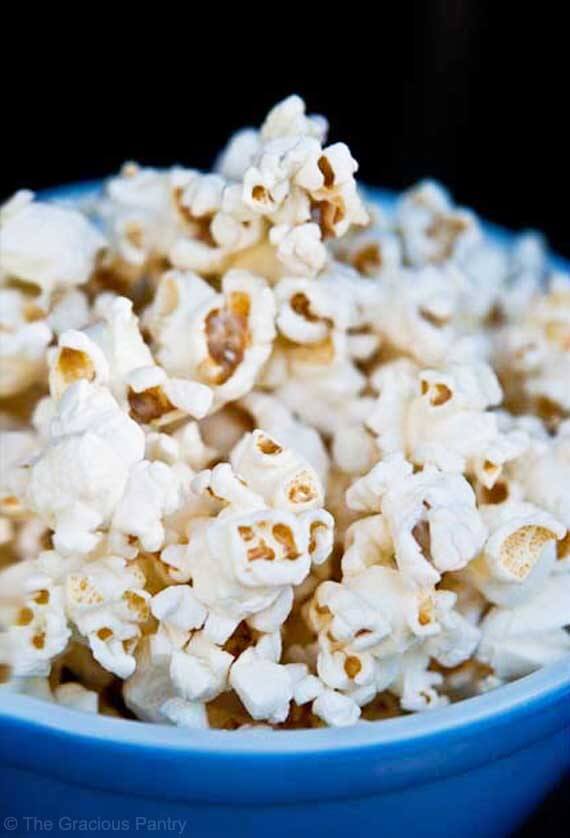 A blue bowl overflowing with healthy coconut oil popcorn