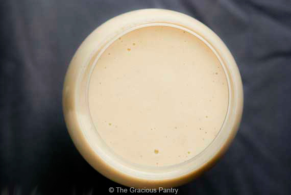 An overhead view of a glass full of homemade eggnog.