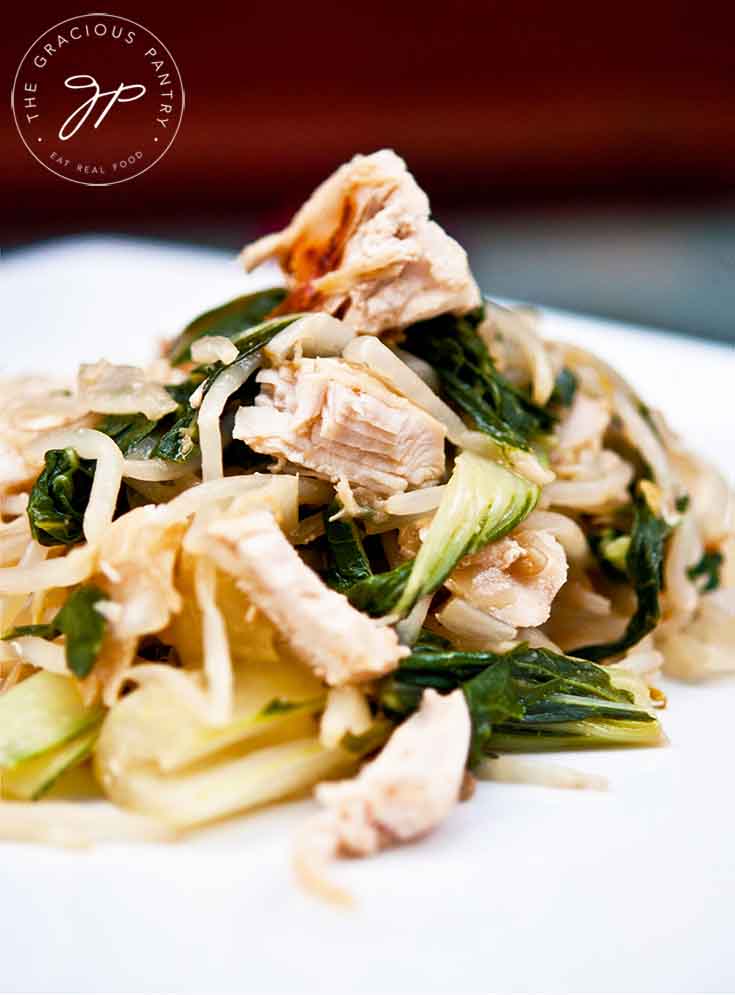 A serving of this Chicken Bok Choy Recipe sits on a white plate, ready to serve.