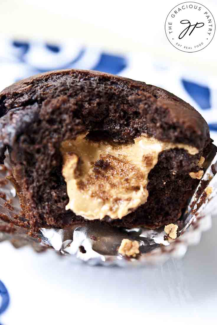 A chocolate chocolate chip muffin, broken open and showing a peanut butter center.