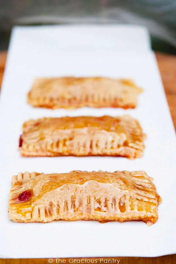 3 Clean Eating Pop Tarts lined up on a long, white platter. They have a honey glaze over the top.