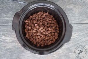 Pour chocolate chips into slow cooker.