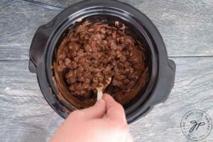 Stirring melting chocolate chips.
