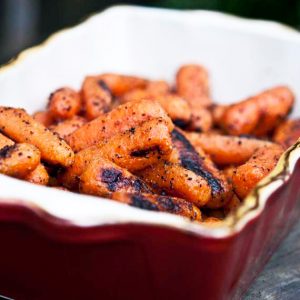 Clean Eating grilled carrots in red casserole dish