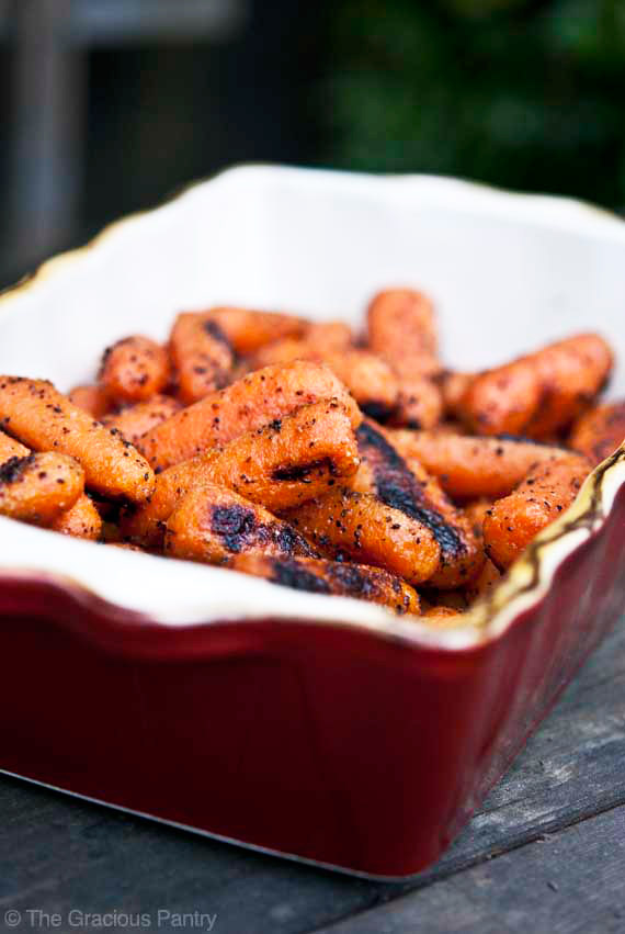 tender grilled carrots in red casserole dish