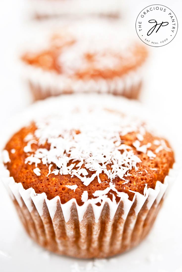 Close up of a row of Coconut Pineapple Muffins sprinkled with coconut shreds.