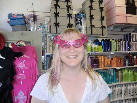 Author wearing pink glasses and a white t-shirt.