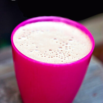 A short, pink cup sits filled with this Chocolate Milkshake.