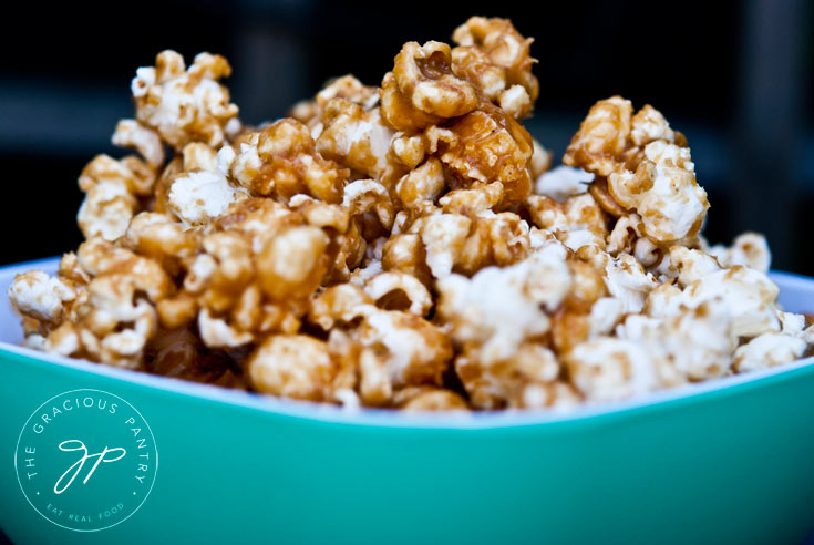 Sticky Caramel Popcorn in an aqua-colored bowl.