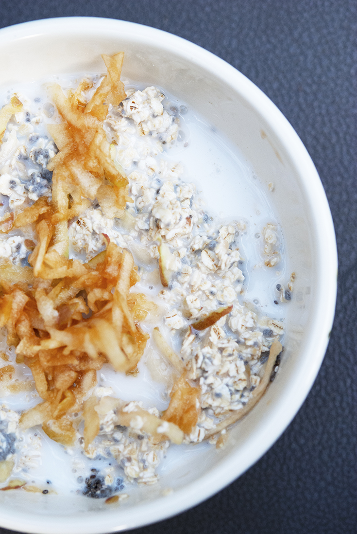 An overhead view looking down into a bowl filled with this apple muesli recipe.
