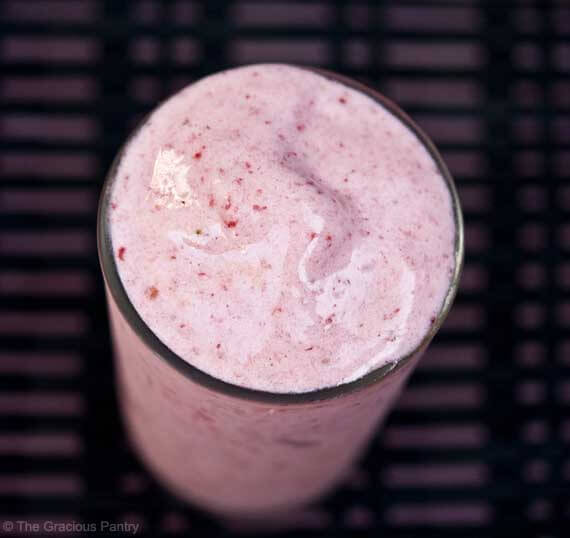 A clear glass sits filled to the top with this Clean Eating Strawberry Banana Ice Cream