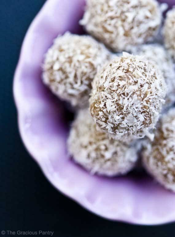 A pink bowl filled with coconut covered Clean Eating Jum Jills.