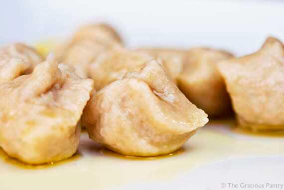 Gnocchi laying on plate in a small amount of olive oil, cooked and ready to eat resulting from this lesson on how to make clean eating gnocchi