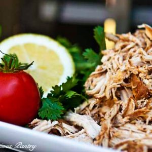 Slow Cooker Mexican Chicken piled high on a white platter.