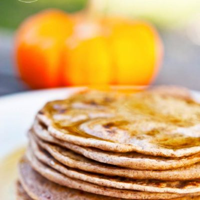 A stack of Pumpkin Spice Pancakes on a white plate