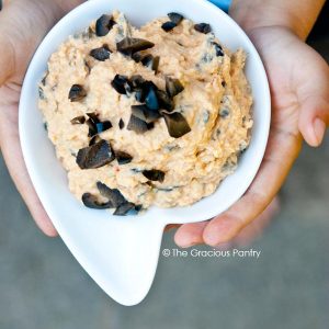 Pizza Hummus being held in a small white bowl.