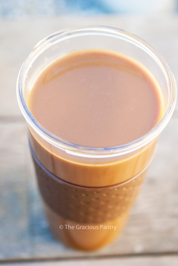 A clean cup stands on a plain background filled with this Clean Eating Coconut Latte.