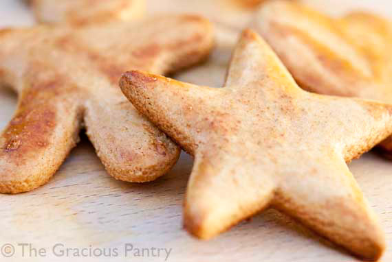 A close up of Whole Wheat Cut Out Cookies laying on a wooden surface.