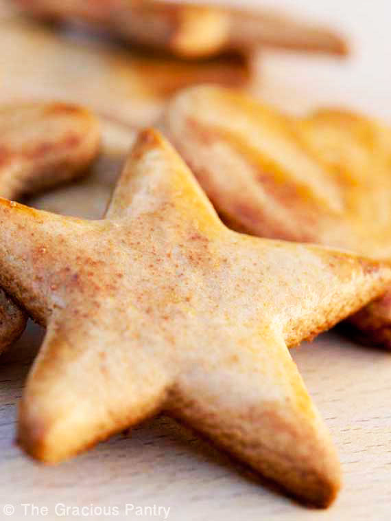 Whole Wheat Cut Out Cookies laying on a cutting board. A start cookie at the front.