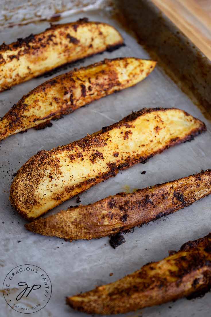 Potato Wedges, hot on a baking pan, golden brown out of the oven.