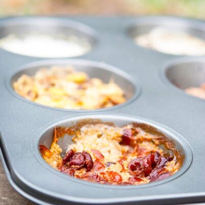 A muffin tin filled with different flavored oats sits ready to serve. Find out how to make this Muffin Tin Oatmeal Recipe below!