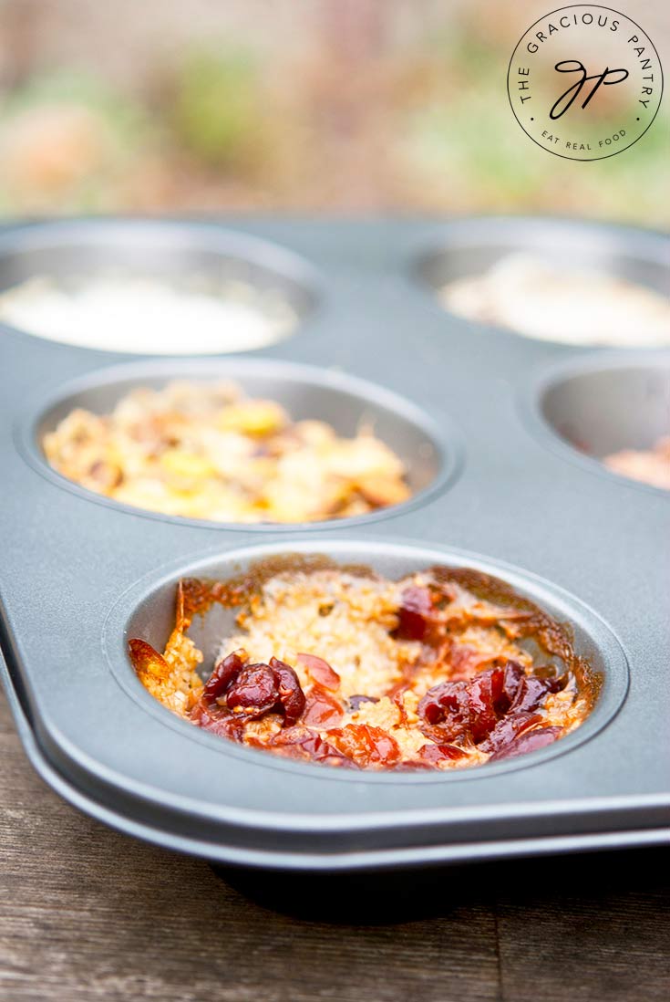 A muffin tin filled with different flavored oats sits ready to serve. Find out how to make this Muffin Tin Oatmeal Recipe below!
