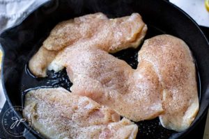 Step three shows the chicken breasts in the skillet, ready to cook.