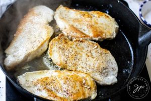 Step four shows the chicken breasts cooking and browning beautifully in the cast iron skillet.