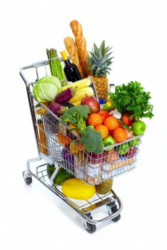 A grocery cart full of fresh produce.