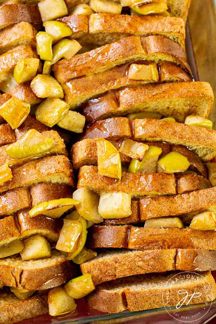 An overhead view of this Apple French Toast Casserole shows the slices of bread and bits of apple stuffed between them.